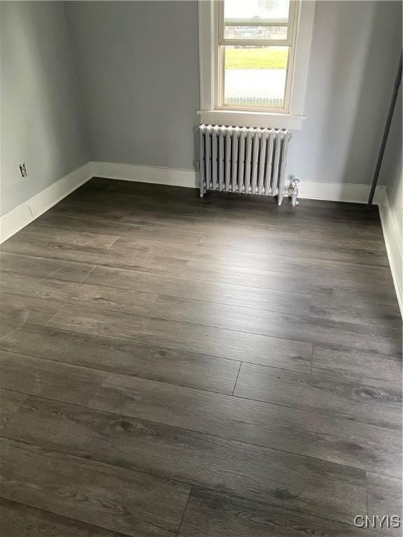 216 S 2nd St, Fulton, NY 13069 - unfurnished room with radiator and dark wood-type flooring