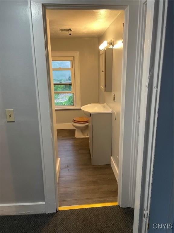 216 S 2nd St, Fulton, NY 13069 - half bathroom featuring vanity and wood finished floors