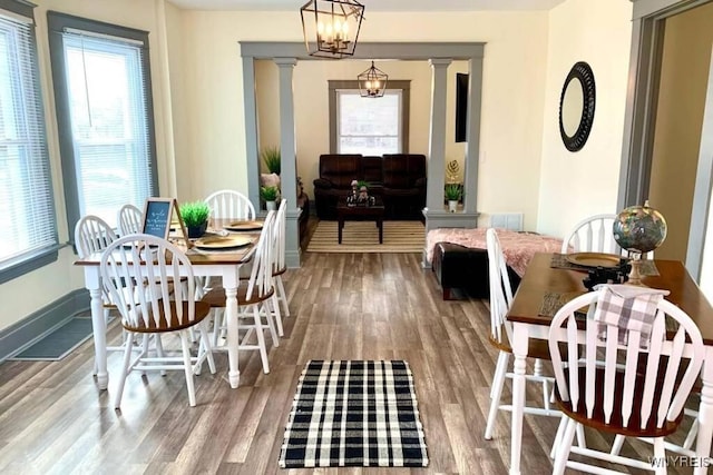 1008 Niagara Ave, Niagara Falls, NY 14305 - dining room with decorative columns, wood finished floors, and healthy amount of natural light