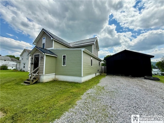 918 Crown St, Olean-City, NY 14760 - view of property exterior with entry steps, a yard, a metal roof, gravel driveway, and an outdoor structure