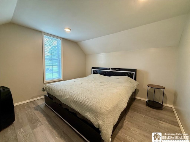 918 Crown St, Olean-City, NY 14760 - bedroom with lofted ceiling and wood finished floors
