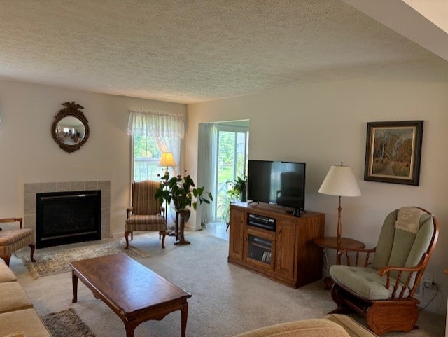 783 Whistlers Cove Ln, Greece, NY 14612 - living room with a textured ceiling, a tile fireplace, and light carpet