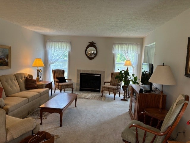 783 Whistlers Cove Ln, Greece, NY 14612 - living area featuring a textured ceiling, plenty of natural light, a tiled fireplace, and light carpet