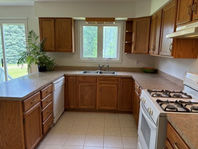 783 Whistlers Cove Ln, Greece, NY 14612 - kitchen featuring white appliances, under cabinet range hood, and brown cabinets