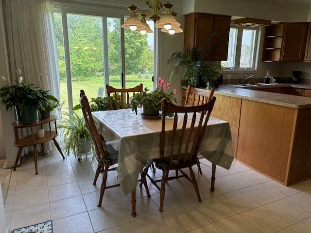 783 Whistlers Cove Ln, Greece, NY 14612 - dining space with a chandelier and light tile patterned floors