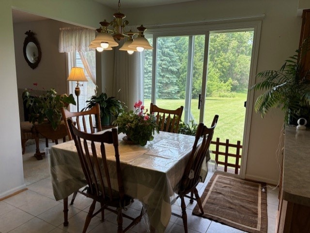 783 Whistlers Cove Ln, Greece, NY 14612 - dining area with a chandelier, light tile patterned floors, and plenty of natural light