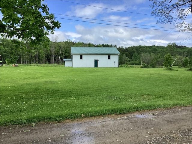 117 Wrench Ln, Coventry, NY 13733 - view of grassy yard with a forest view, an outdoor structure, and an outbuilding