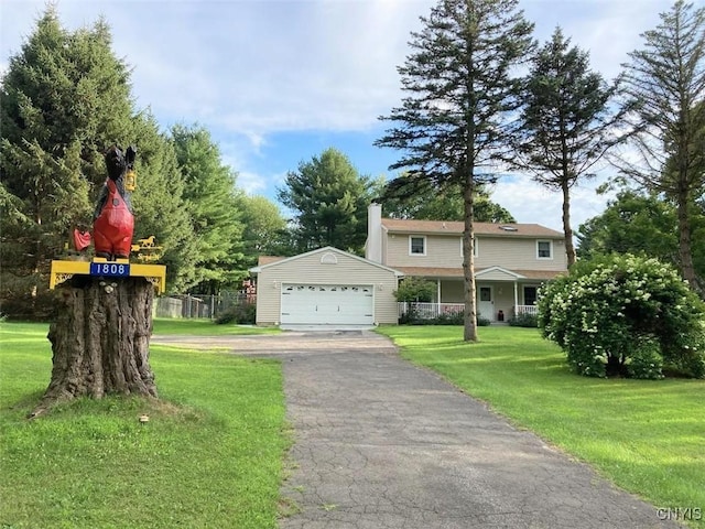 1808 Mulholland Rd, Vienna, NY 13123 - view of front of home with a detached garage, an outdoor structure, a front yard, and a chimney