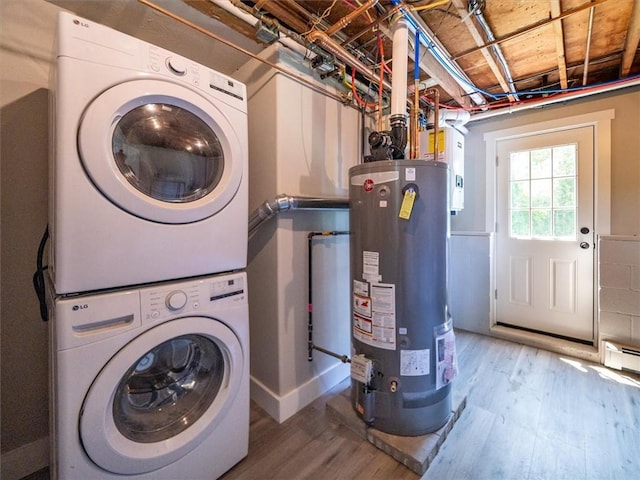 1333 Wayneport Rd, Macedon, NY 14502 - laundry area with stacked washing machine and dryer, gas water heater, and wood finished floors