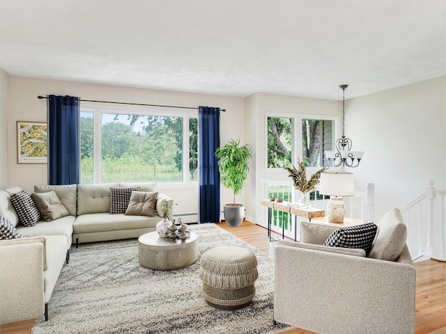 1333 Wayneport Rd, Macedon, NY 14502 - living room featuring light wood-type flooring, baseboard heating, and a chandelier