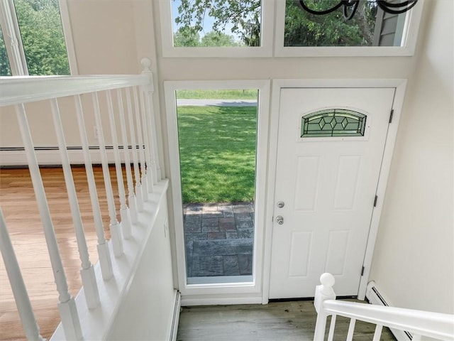 1333 Wayneport Rd, Macedon, NY 14502 - entrance foyer with baseboard heating, wood finished floors, and healthy amount of natural light
