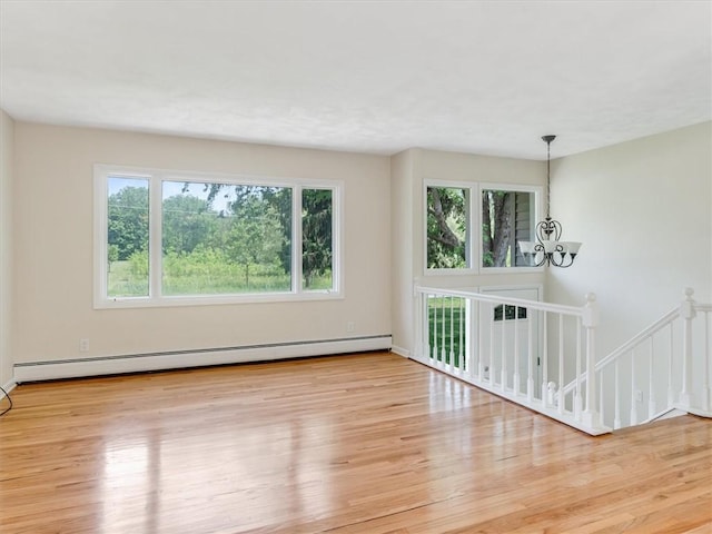 1333 Wayneport Rd, Macedon, NY 14502 - unfurnished room featuring a baseboard heating unit, plenty of natural light, and wood finished floors