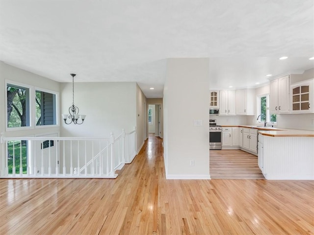 1333 Wayneport Rd, Macedon, NY 14502 - kitchen featuring stainless steel appliances, white cabinets, light wood-type flooring, glass insert cabinets, and recessed lighting