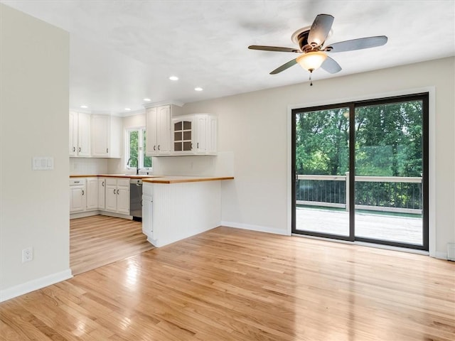 1333 Wayneport Rd, Macedon, NY 14502 - kitchen with a peninsula, white cabinets, light wood-type flooring, stainless steel dishwasher, and ceiling fan