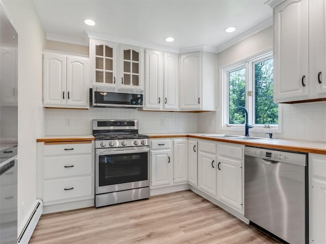 1333 Wayneport Rd, Macedon, NY 14502 - kitchen featuring stainless steel appliances, a baseboard radiator, ornamental molding, light countertops, and white cabinets