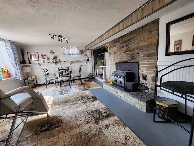 8637 State Route 415, Campbell, NY 14821 - living area with a textured ceiling and a wood stove