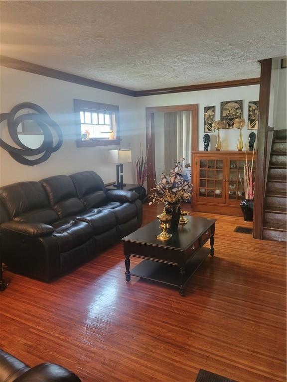 235 Congress Ave, Rochester, NY 14611 - living room with wood finished floors, a textured ceiling, ornamental molding, and stairs