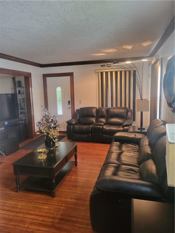 235 Congress Ave, Rochester, NY 14611 - living room featuring a textured ceiling, wood finished floors, and ornamental molding