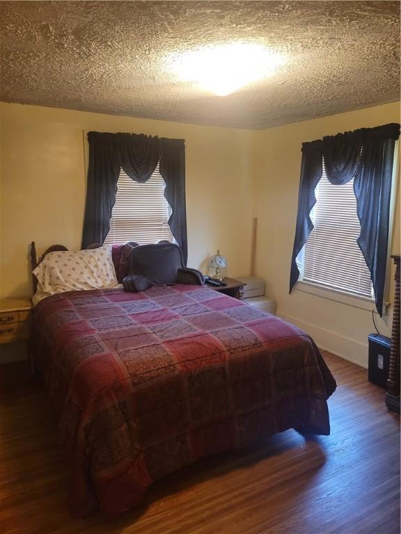 235 Congress Ave, Rochester, NY 14611 - bedroom featuring wood finished floors and a textured ceiling