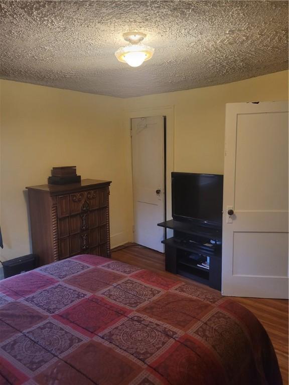 235 Congress Ave, Rochester, NY 14611 - bedroom featuring wood finished floors and a textured ceiling