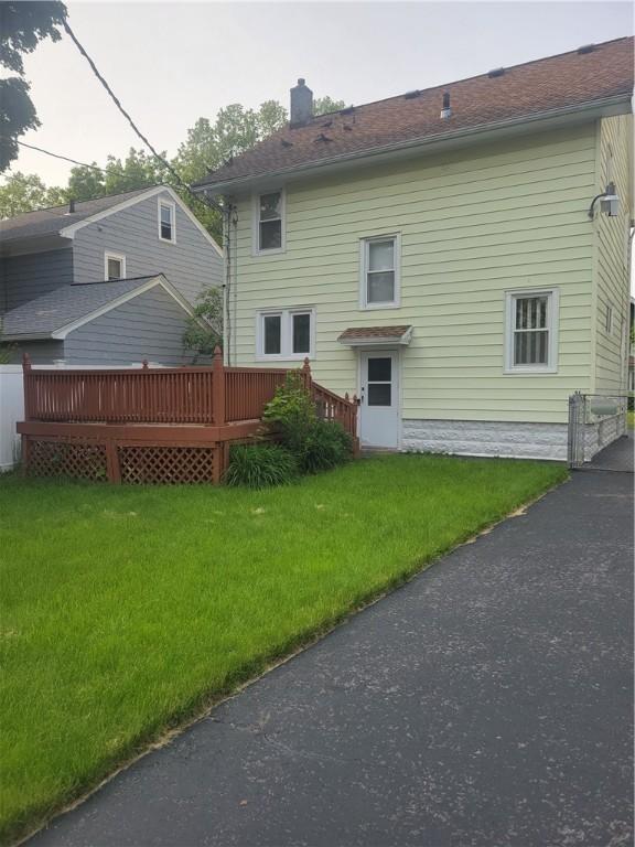 235 Congress Ave, Rochester, NY 14611 - back of house featuring a chimney, a wooden deck, and a lawn