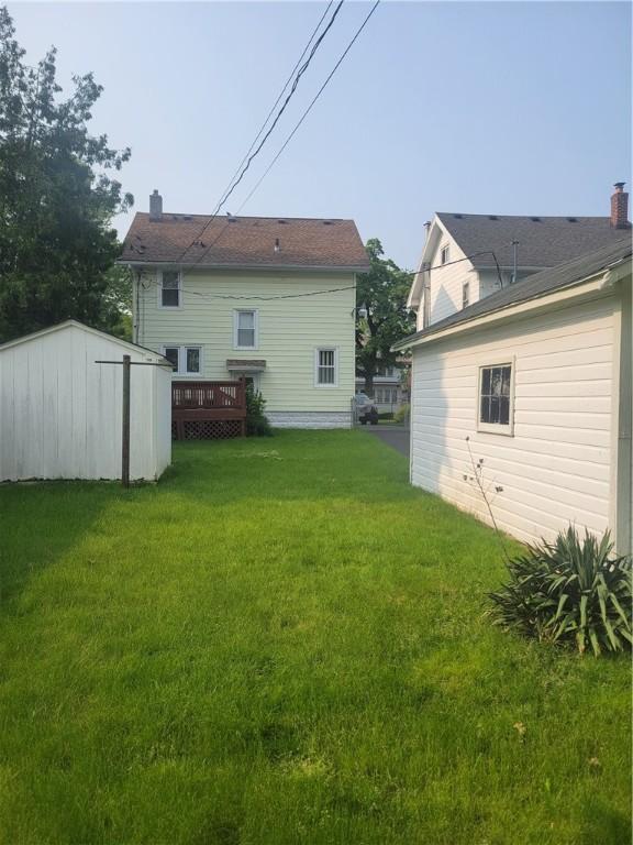 235 Congress Ave, Rochester, NY 14611 - rear view of property with a lawn, a deck, and a shed