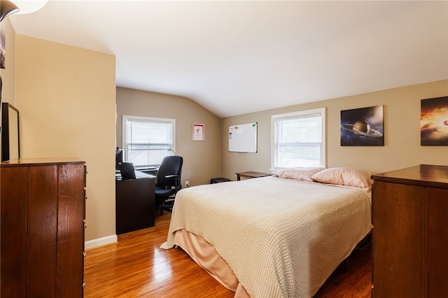 3389 Culver Rd, Irondequoit, NY 14622 - bedroom featuring vaulted ceiling, light wood-type flooring, multiple windows, and a desk