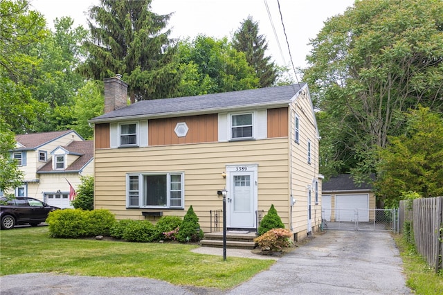 3389 Culver Rd, Irondequoit, NY 14622 - view of front of house featuring a chimney, an outdoor structure, a garage, and driveway
