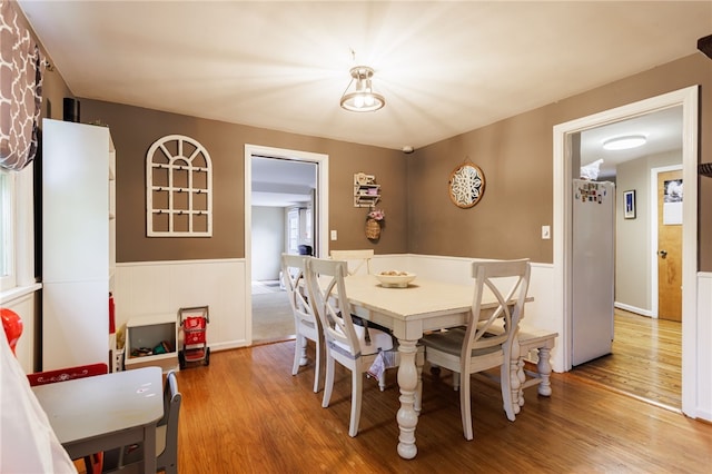 3389 Culver Rd, Irondequoit, NY 14622 - dining room featuring a wainscoted wall and wood finished floors