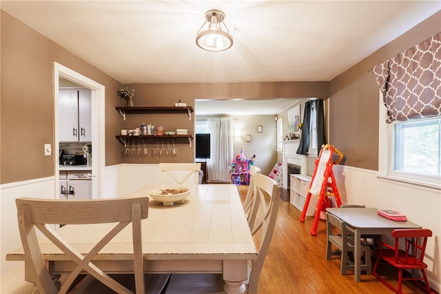 3389 Culver Rd, Irondequoit, NY 14622 - dining space featuring wainscoting and light wood-style flooring