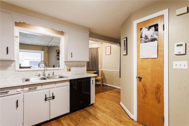 3389 Culver Rd, Irondequoit, NY 14622 - kitchen featuring dishwasher, light countertops, light wood-style floors, and white cabinets