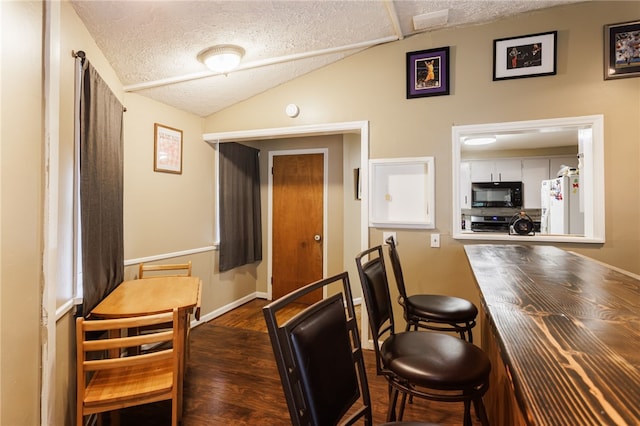 3389 Culver Rd, Irondequoit, NY 14622 - dining area with a textured ceiling, wood finished floors, and lofted ceiling
