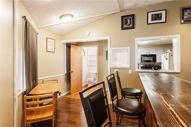 3389 Culver Rd, Irondequoit, NY 14622 - dining room with a textured ceiling, lofted ceiling, and wood finished floors