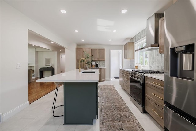 165 Culver Pkwy, Irondequoit, NY 14609 - kitchen featuring appliances with stainless steel finishes, wall chimney range hood, tasteful backsplash, a kitchen breakfast bar, and light countertops