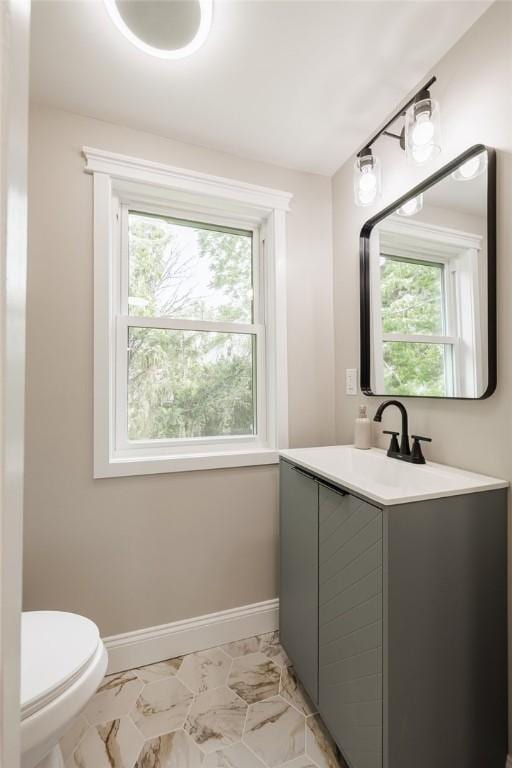 165 Culver Pkwy, Irondequoit, NY 14609 - half bathroom featuring healthy amount of natural light, vanity, and marble look tile flooring