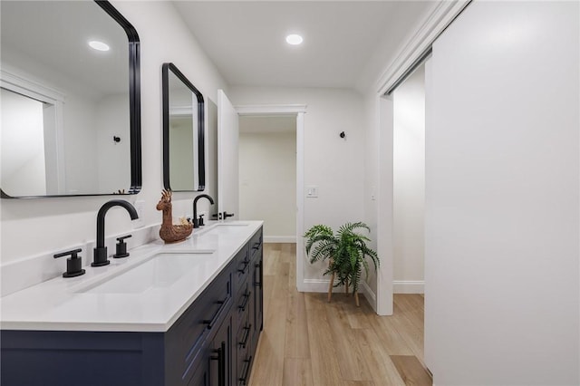 165 Culver Pkwy, Irondequoit, NY 14609 - bathroom featuring wood finished floors, double vanity, and recessed lighting