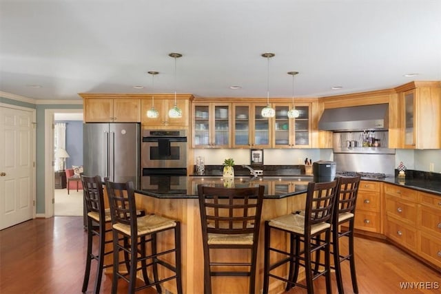 117 Halwill Dr, Amherst, NY 14226 - kitchen with stainless steel appliances, wall chimney exhaust hood, dark wood-type flooring, a kitchen island, and crown molding