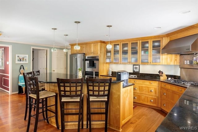 117 Halwill Dr, Amherst, NY 14226 - kitchen with wall chimney range hood, appliances with stainless steel finishes, wood finished floors, a center island, and pendant lighting