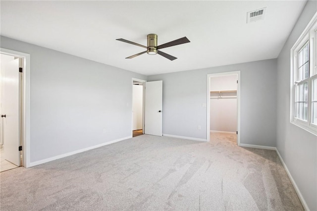 1A Salmon Run, Parma, NY 14468 - unfurnished bedroom with carpet floors, a spacious closet, ceiling fan, ensuite bath, and a closet