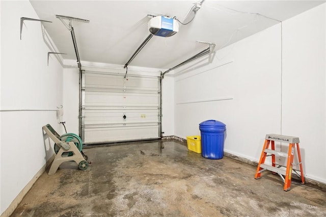 1A Salmon Run, Parma, NY 14468 - garage featuring a garage door opener and baseboards