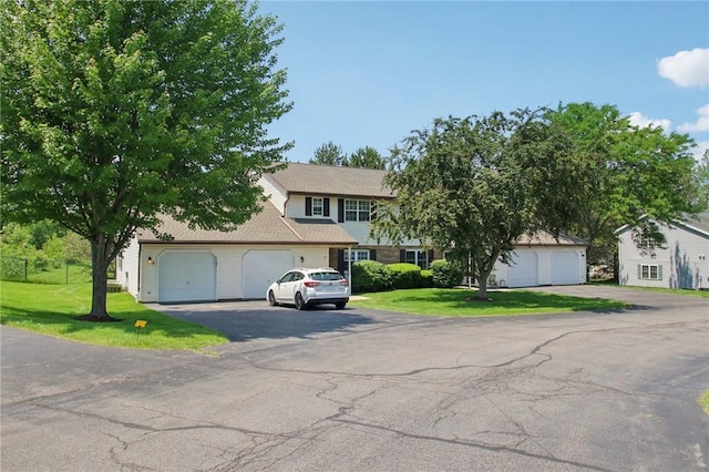 1A Salmon Run, Parma, NY 14468 - view of front facade featuring a front lawn, asphalt driveway, and a garage
