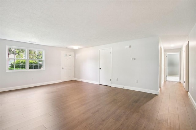 1A Salmon Run, Parma, NY 14468 - unfurnished room featuring dark wood-type flooring and a textured ceiling