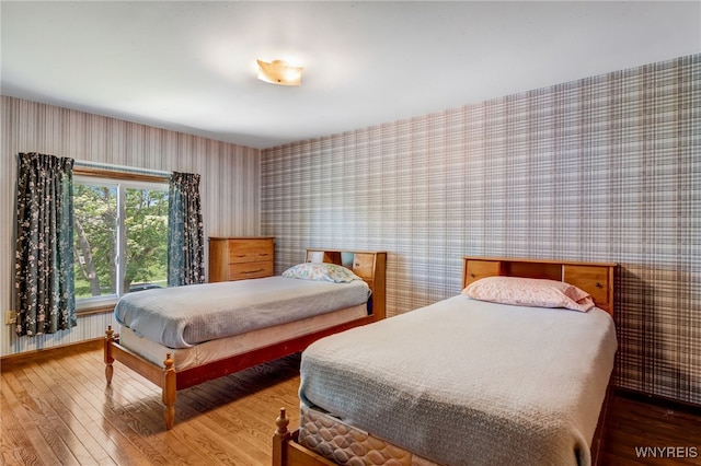 172 Shetland Dr, Amherst, NY 14221 - bedroom featuring wallpapered walls, wood finished floors, and radiator