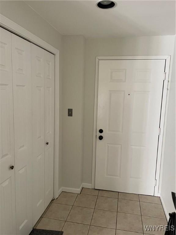 138 Charter Oaks Dr Unit B, Amherst, NY 14228 - foyer entrance with light tile patterned flooring and baseboards