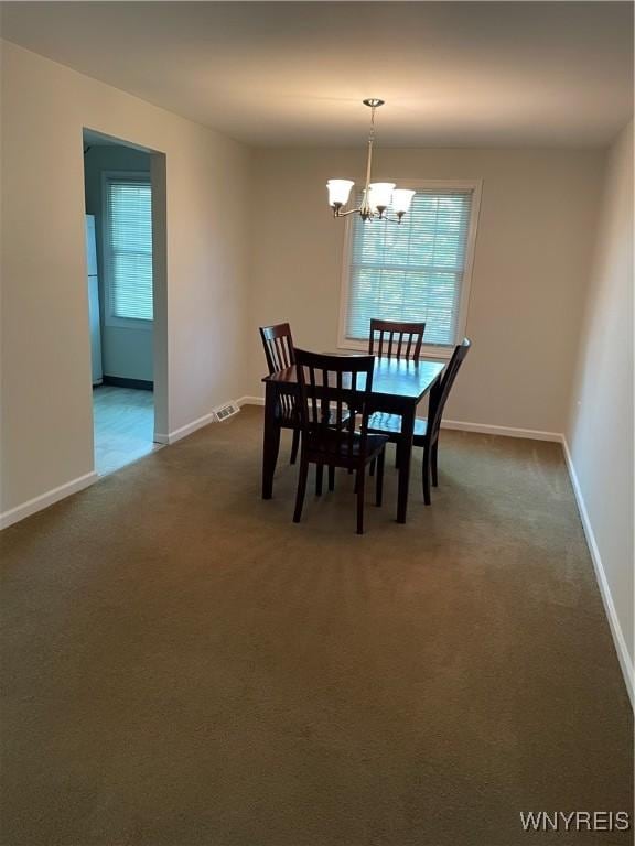 138 Charter Oaks Dr Unit B, Amherst, NY 14228 - dining room with a chandelier and dark colored carpet