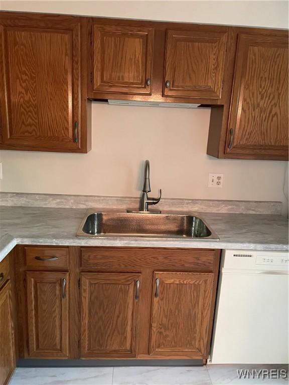 138 Charter Oaks Dr Unit B, Amherst, NY 14228 - kitchen with dishwasher, light countertops, and brown cabinetry
