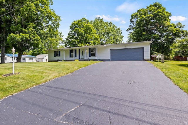1372 Canandaigua Rd, Macedon, NY 14502 - ranch-style house featuring asphalt driveway, an attached garage, a front yard, and covered porch