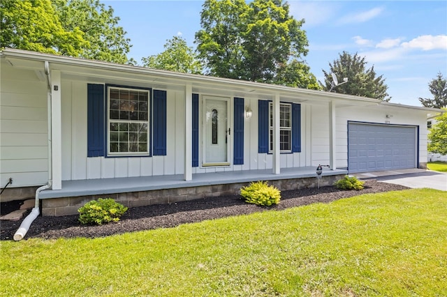 1372 Canandaigua Rd, Macedon, NY 14502 - ranch-style house with a porch, a front yard, an attached garage, and driveway