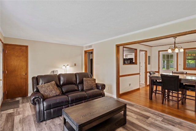 1372 Canandaigua Rd, Macedon, NY 14502 - living area with wood finished floors, a chandelier, and ornamental molding
