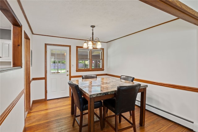 1372 Canandaigua Rd, Macedon, NY 14502 - dining room featuring light wood finished floors, baseboard heating, a chandelier, ornamental molding, and a textured ceiling